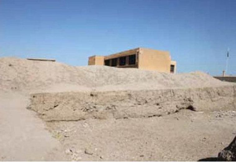 A bulldozer cut into part of the ancient city of Hamoukar by contractors building an addition to a school. Without protection at the site, modern-day buildings are being erected over it. Image taken in April 2012.