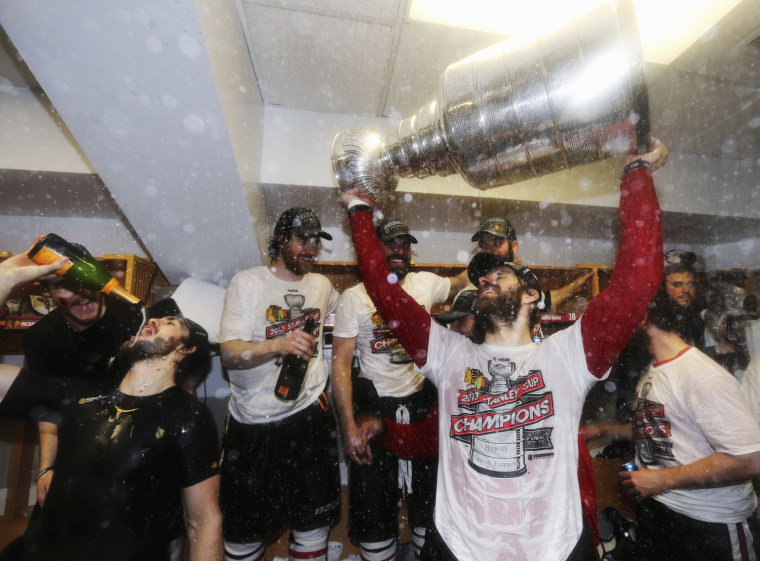 Michal Handzus of the Chicago Blackhawks celebrates with the Stanley Cup in the locker room after his team defeated the Boston Bruins in Game Six of their NHL Stanley Cup Finals hockey series in Boston, Mass., on June 24, 2013.