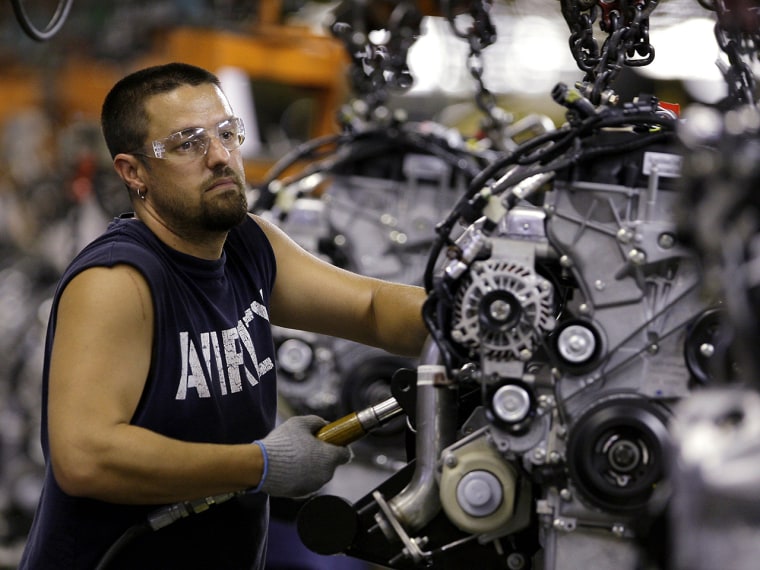 In this Aug. 26, 2009 photo, Chris Wasmer, of Kearney, Mo., works on an engine for a 2010 Ford Escape at Ford's Kansas City Assembly Plant in Claycomo...