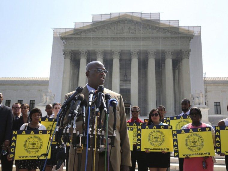 NAACP National Field Director Rev. Charles White speaks to reporters after the U.S. Supreme Court struck down part of a federal law designed to protect minority voters, at the court's building in Washington, June 25, 2013.