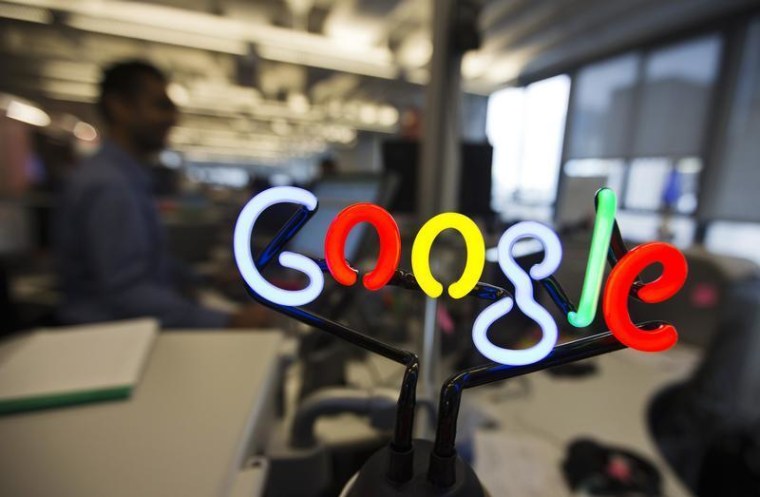 A neon Google logo is seen as employees work at the new Google office in Toronto, November 13, 2012. REUTERS/Mark Blinch
