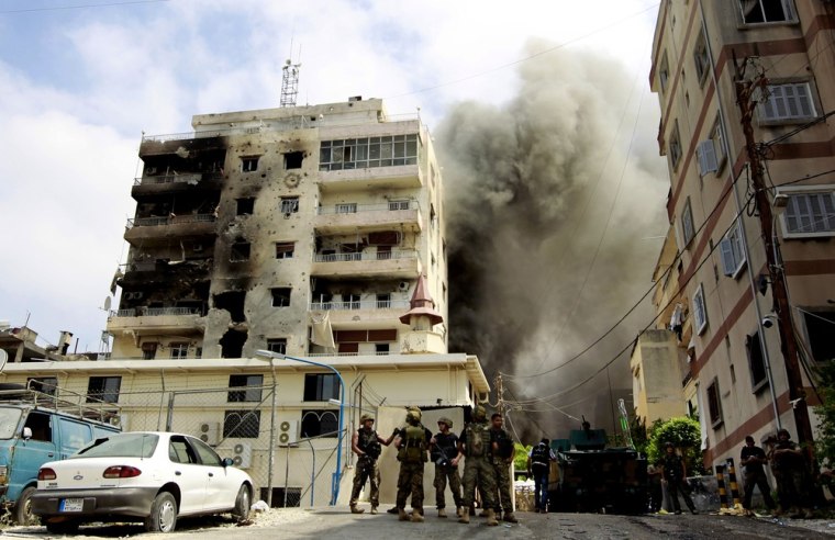 Black smoke rises from the Bilal bin Rabbah Mosque where Sunni cleric Sheik Ahmad al-Assir preaches, while Lebanese troops detonate booby traps, in the southern port city of Sidon, Lebanon, on June 25.