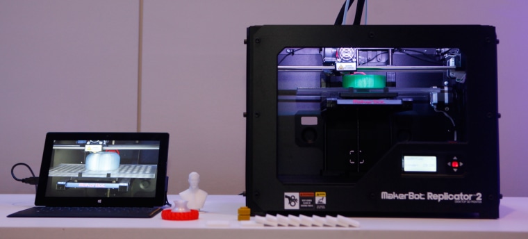 A Surface tablet connected to a MakerBot 3-D printer.