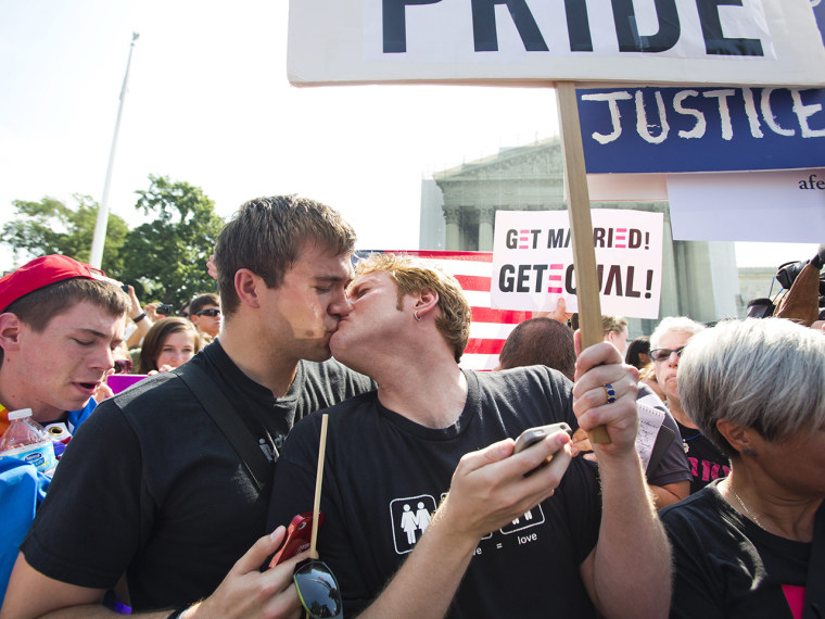 Like many same-sex couples when they heard the news, Michael Knaapen (L) and John Becker (R), a gay couple from Washington, DC, who married seven years ago in Toronto, shared a kiss.