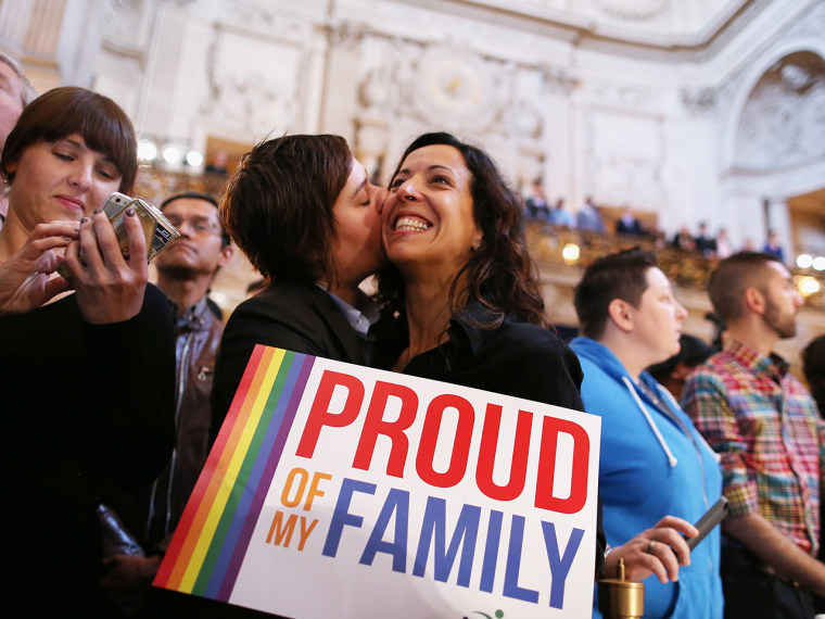 A couple at a rally in San Francisco celebrates the Supreme Court decisions, including one that will allow gay marriage to resume in California after it was banned in 2008.