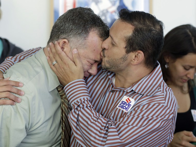 In addition to smiles and hugs among gay couples, there were also some tears like those from Jeff Ronci (left), who got a kiss from partner Juan Talavera at a party in Miami to watch the Supreme Court rulings.