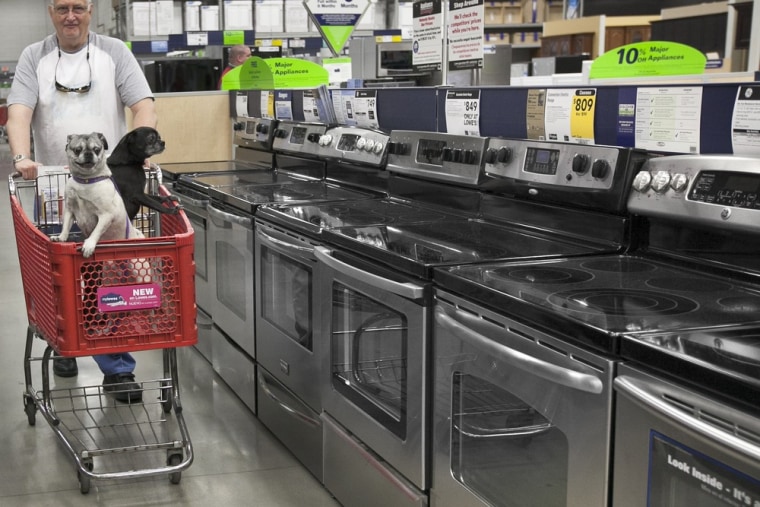 Hmm, maybe we should head over to the gas appliance aisle. Tom Klitzke of Omaha walks his pugs Max, left, and Bear, right, past home appliances at a L...