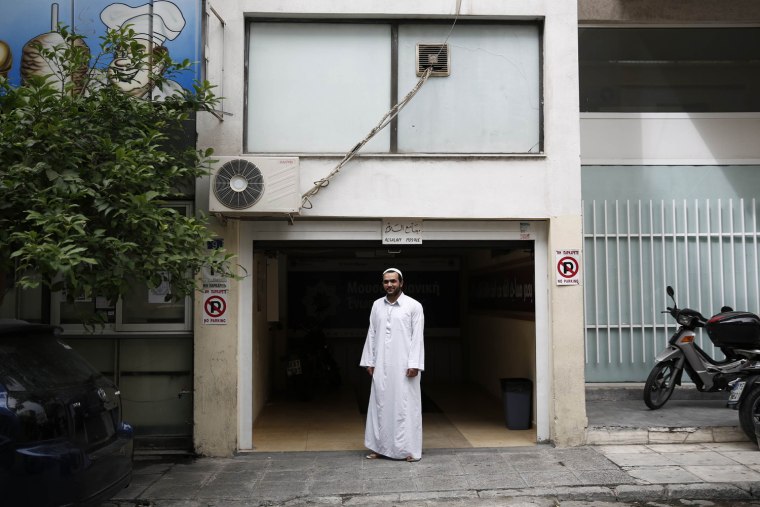 Egyptian imam Mohamed Noaman, 32, poses at the entrance of Alsalam makeshift mosque at Neos Kosmos suburb in Athens May 17, 2013.