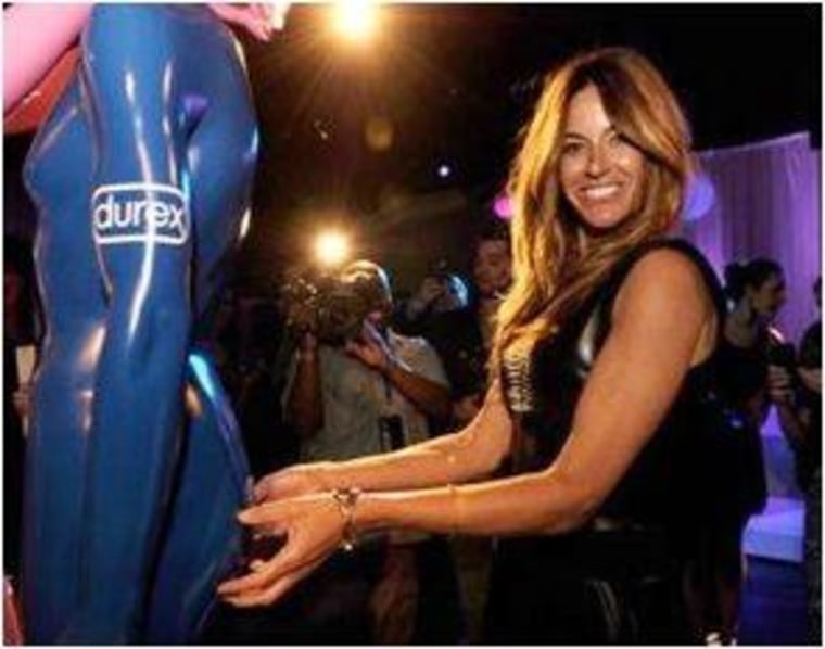 Kelly Bensimon leaving her mark on the his and hers Durex statues. Durex donated money to dance4life for every celeb signature.