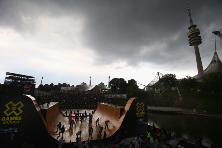 Helpers dry the vert ramp after a rain shower on Day 1 of the X-Games on June 27, 2013 in Munich, Germany.