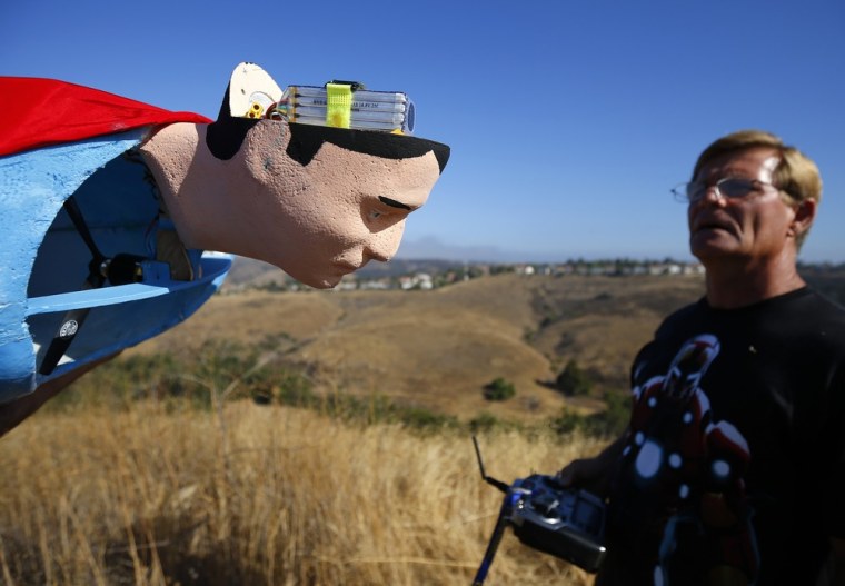 A radio-controlled Superman plane has a new battery placed inside its head as designer Otto Dieffenbach prepares for a test flight in San Diego, Calif.