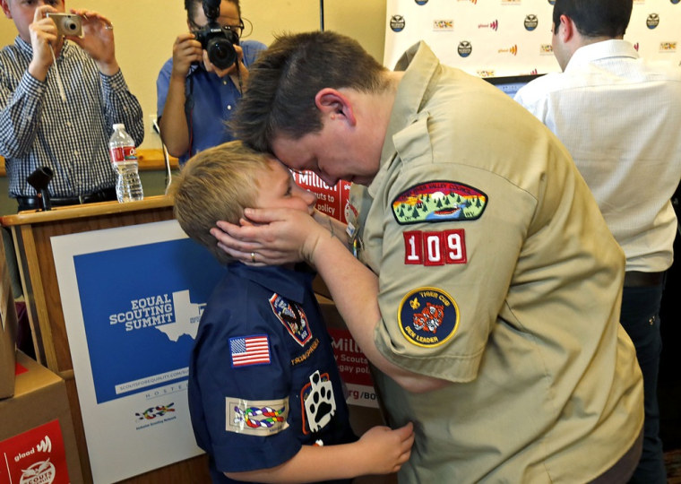 Jennifer Tyrrell of Bridgeport, Ohio, a Cub Scout den leader who was kicked out in 2012 for being openly gay, embraces her son Cruz Burns, 8, before a news conference at the Great Wolf Lodge May 23, 2013 in Grapevine, Texas.
