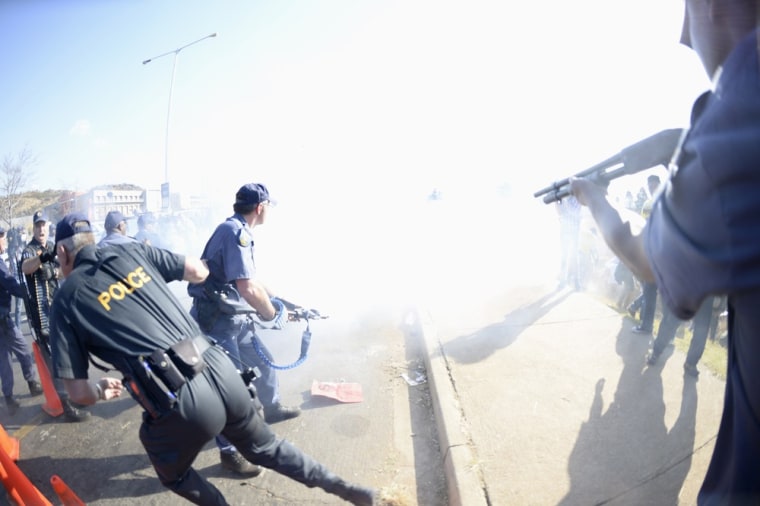 Smoke fills the air as police use stun grenades in an attempt to disperse protesters outside the University of Johannesburg in Soweto, ahead of a visit by U.S. President Barack Obama, June 29, 2013.