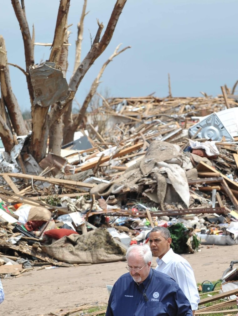 President Barack Obama walks with FEMA Director Craig Fugate, as he tours a tornado affected area on May 26, 2013 in Moore, Oklahoma. Obama is in the Oklahoma City area to survey damage from the tornado which struck a week ago and meet with victims and first responders.