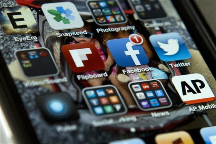 A view of an iPhone in Washington Tuesday, May 21, 2013, showing the Twitter and Facebook apps among others. A new poll finds that teens are sharing m...