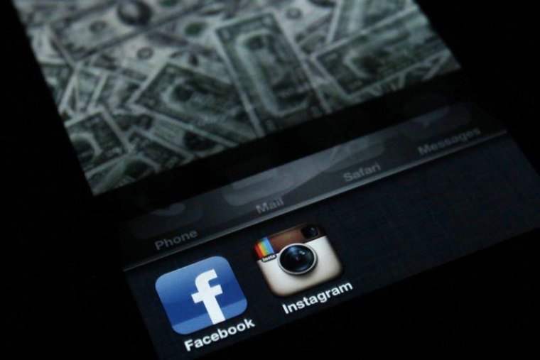 A photo illustration shows the applications Facebook and Instagram on the screen of an iPhone in Zagreb April 9, 2012. REUTERS/Antonio Bronic