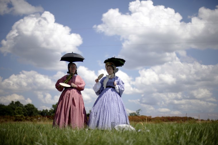 Re-enactors watch a demonstration of a battle during ongoing activities commemorating the 150th anniversary of the Battle of Gettysburg, June 29, at Bushey Farm in Gettysburg, Pa. Union forces turned away a Confederate advance in the pivotal battle of the Civil War which was also the war's bloodiest conflict with more than 51,000 casualties.