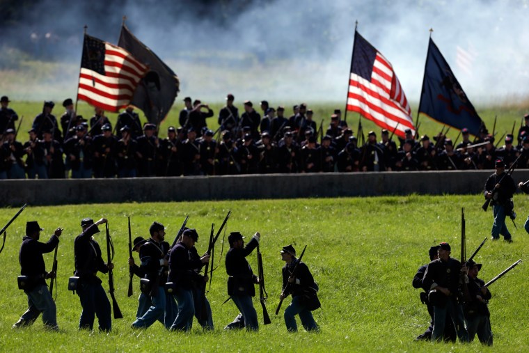 Re-enactors take part in a demonstration of a battle.