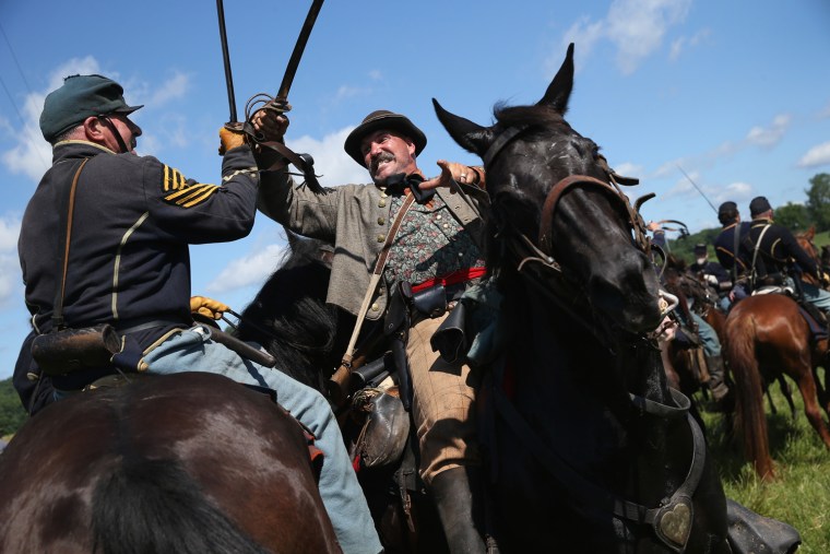 Union and Confederate re-enactors skirmish during a re-enactment of the Battle of Gettysburg on June 29, in Gettysburg, Pa. Over three days, more than 10,000 re-enactors will pay tribute to the battle that took place in Gettysburg on July 1-3, 1863, during the 1861-1865 US Civil War.