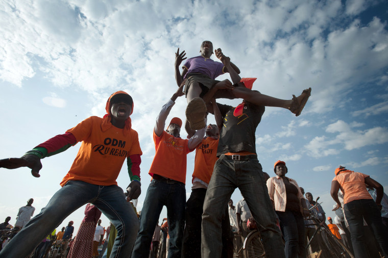 Supporters of Raila Odinga celebrate as Raila takes the stage during a major rally in Kisumu town on March 1, 2013.
