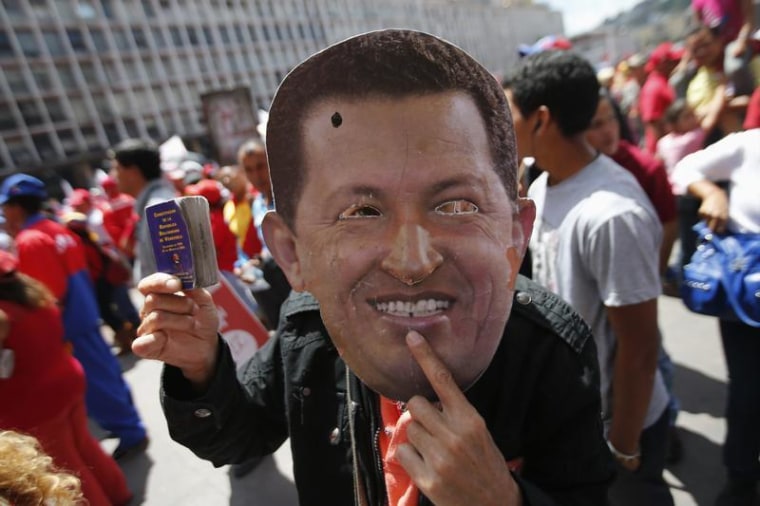A supporter of Venezuela's President Hugo Chavez wears a mask depicting him during a rally in Caracas Feb. 27, 2013.