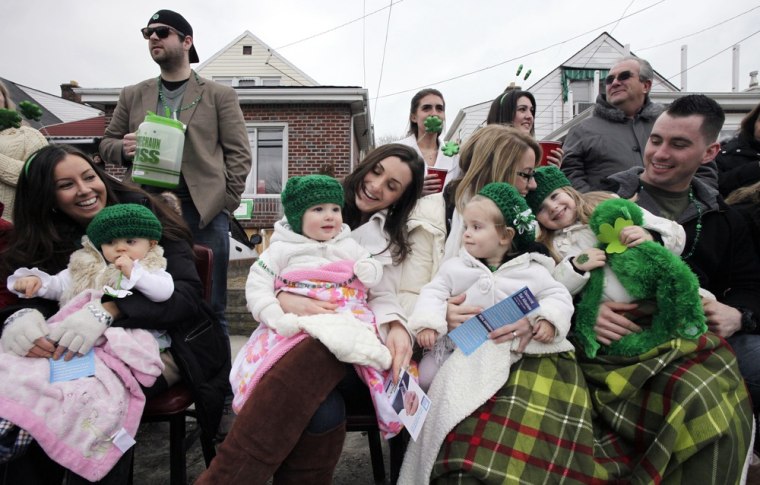 Families watch the Queens County St. Patrick's Day Parade in the Rockaway section of New York on Saturday.