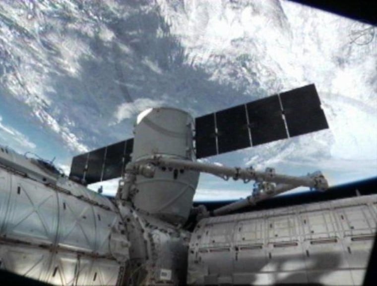 A view from one of the International Space Station's cameras shows the Dragon cargo capsule berthed to the Harmony module.