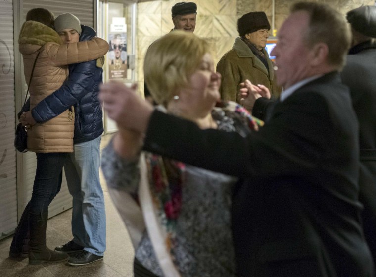 A couple hug as Mykola Milevsky and Natalia Stolyarenko dance.