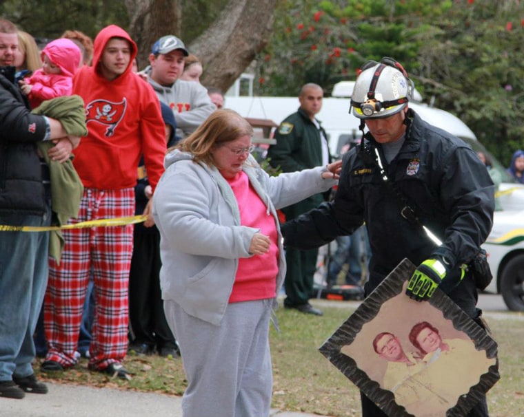 HCFR's Captain Roberts presents family member Jennell with a photo that was recovered. Jennell said it was only picture she had of her mother.
