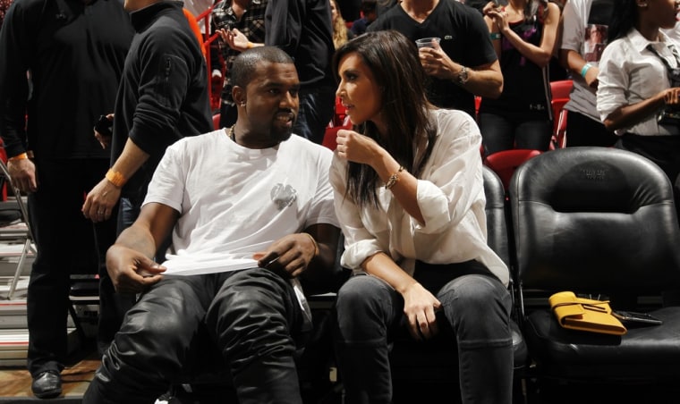 MIAMI, FL - DECEMBER 6: Recording Artist Kanye West and Reality Star Kim Kardashian talk prior to the New York Knicks , Miami Heat game on December 6,...