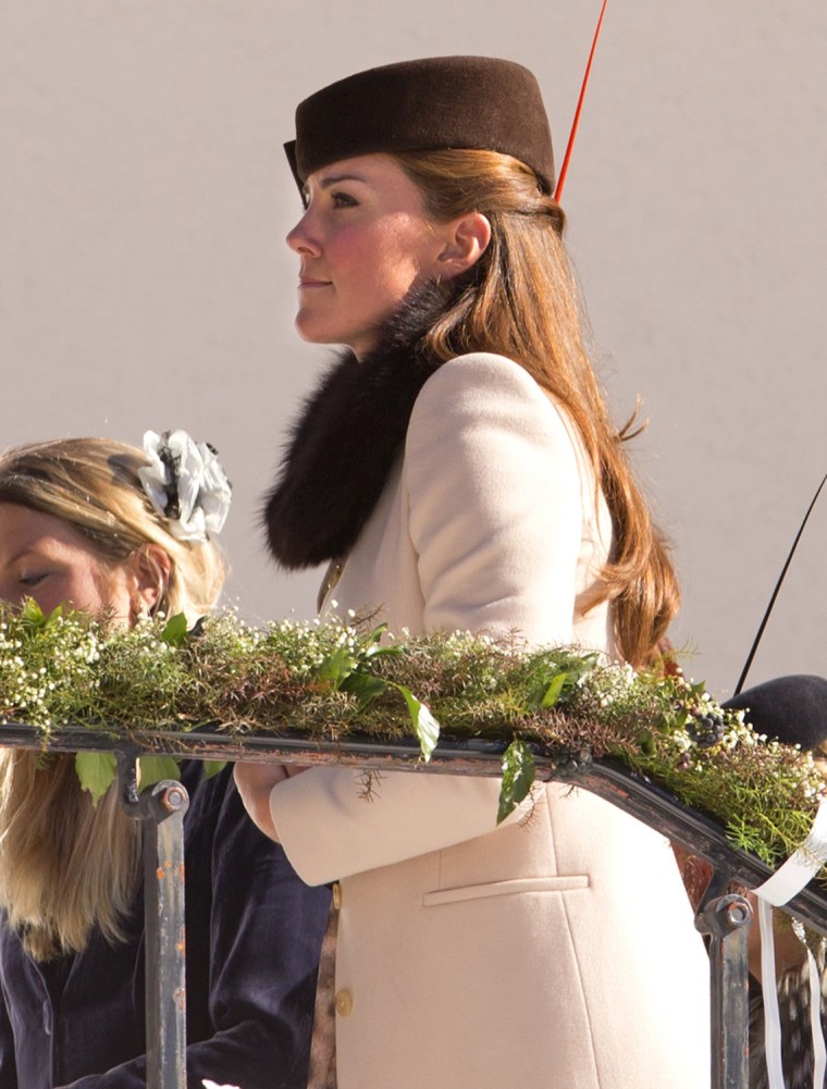 The Duchess of Cambridge had her famous baby bump bundled up under an elegant woolen cream coat and brown pillbox hat at the wedding of friends in the Swiss Alps on Saturday.