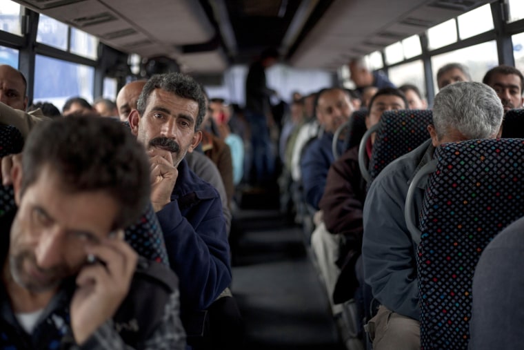 Workers ride a Palestinian-only bus en route to the West Bank from Tel Aviv on Monday.