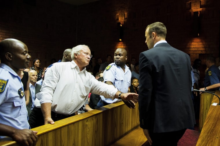 Henke Pistorius (second left), seen in court here with his son Oscar (right), claimed the family had guns for protection and attacked South Africa's ANC government over crime levels.