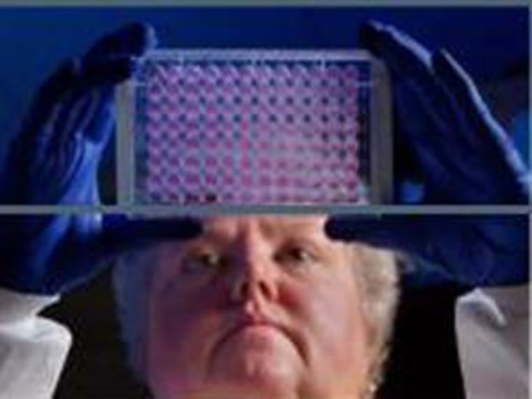CDC microbiologist Kitty Anderson holds up a 96-well plate used to test the ability of bacteria to grow in the presence of antibiotics. CDC officials report that Carbapenem-resistant enterobacteriaceae are on the rise in U.S. hospitals.