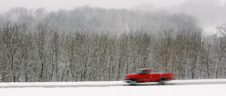 A truck drives along U.S. 151 south of Dubuque, Iowa during a winter snow storm Tuesday March 5. Forecasters say more snow is on the way to snarl travel and disrupt people's daily routines.
