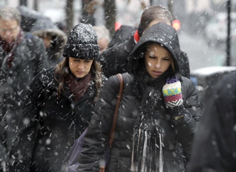 Commuters brace the snow as they arrive in downtown Chicago on March 5. Chicago was hit Tuesday by a storm expected to dump as much as 10 inches of snow in the area before the end of the day — the most since the 2011 blizzard.