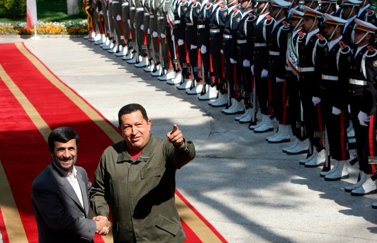 Iranian President Mahmoud Ahmadinejad (L) and Venezuelan President Hugo Chavez during a ceremony marking the start of a two-day visit in Tehran, in a file photo dated April 2, 2009.