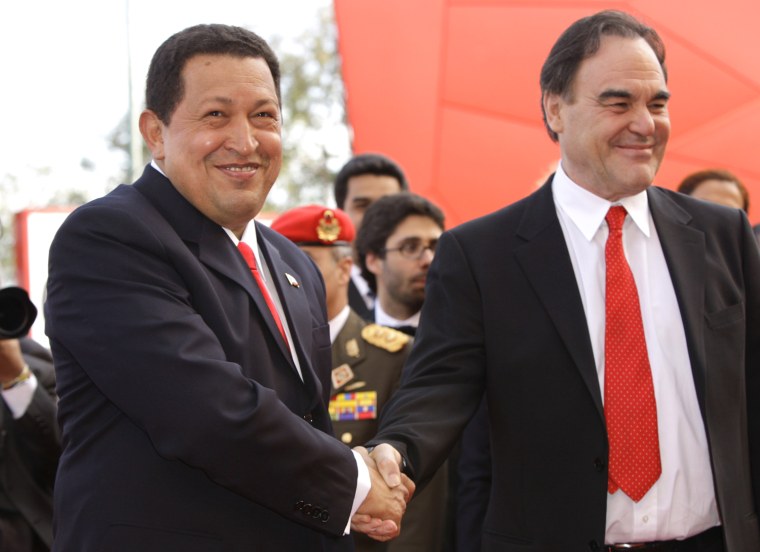 Venezuela's President Hugo Chavez shakes hands with director Oliver Stone as they arrive for the screening of the film 'South of the Border' at the 66th edition of the Venice Film Festival in Venice, Italy, Sept. 7, 2009.