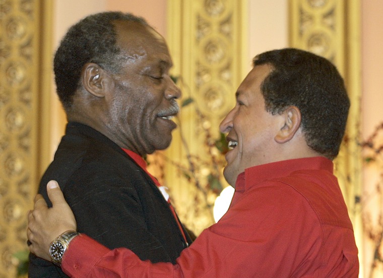 File picture dated Sept. 21, 2006 shows Venezuelan President Hugo Chavez and actor/activist Danny Glover hugging each other while attending The CITGO-Venezuela Heating Oil Program inauguration ceremony at the Mt. Olivet Baptist Church in Harlem, New York.