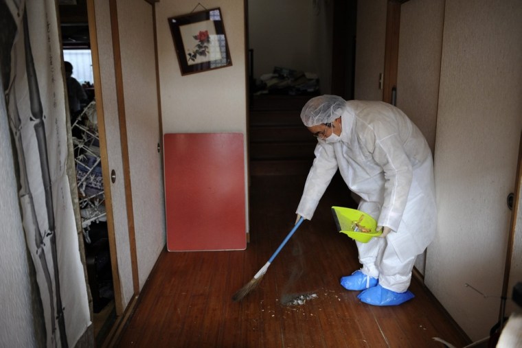 Yuzo Mihara cleans the couple's house, which has been invaded by mice.