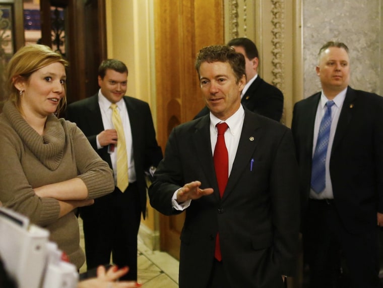 Sen. Rand Paul, R-Ky., walks off the floor of the Senate to applause after his filibuster of the nomination of John Brennan to be CIA director on Capitol Hill, early Thursday, March 7, 2013.