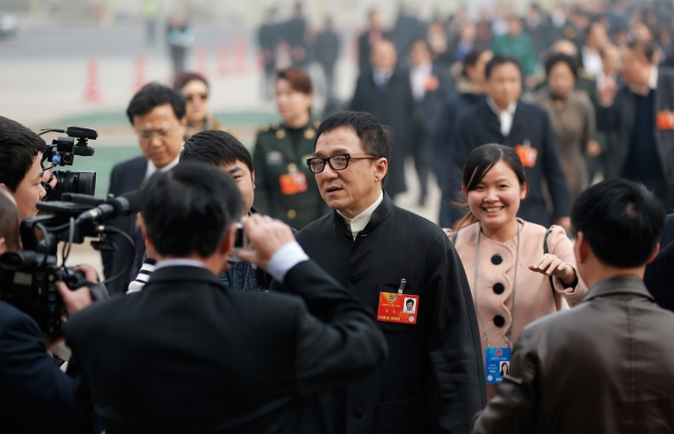 Hong Kong movie star Jackie Chan is surrounded by journalists and outside the plenary session of the Chinese People's Political Consultative Conference on March 7, 2013 in Beijing, China.