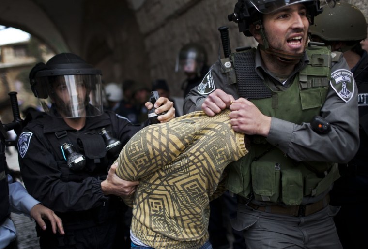 A Palestinian man is detained by Israeli security forces in Jerusalem's Old City on March 8, 2013.