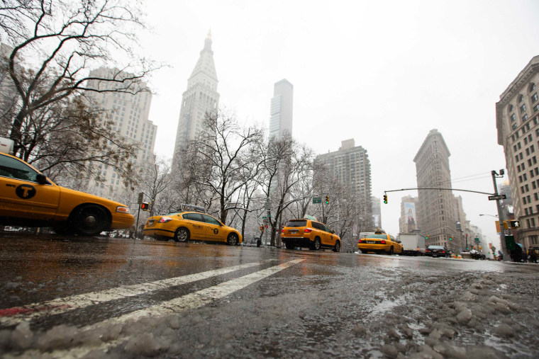 New York taxi cabs drive past the Flatiron building in New York, on March 8.