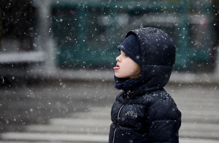 A girl tries to catch snow on her tongue during a snow storm in New York City, on March 8.