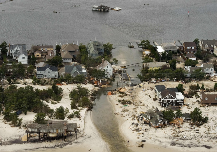 Superstorm Sandy swept a house into the bay, at the site of a new inlet formed when Sandy came ashore, near Mantoloking, N.J. in Oct. 31, 2012. Sandy...