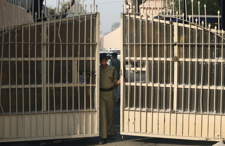 An Indian police officer prepares to close one of the gates at Tihar Jail, the largest complex of prisons in South Asia, in New Delhi on March 11. Indian police confirmed that Ram Singh, one of the men on trial for his alleged involvement in the gang rape and fatal beating of a woman aboard a New Delhi bus, hanged himself at the jail Monday, but his lawyer and family allege he was killed.