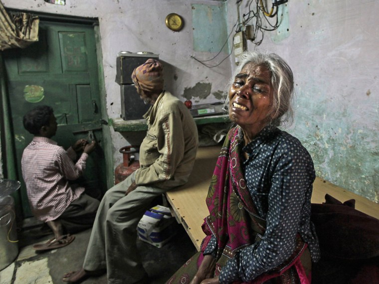 The mother of Ram Singh, the man accused of driving the bus on which a 23-year-old student was gang raped in December 2012, cries as she speaks to journalists inside the family's home in New Delhi on March 11.