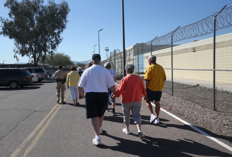 A deputy leads a tour group at the Maricopa County Tent City jail.