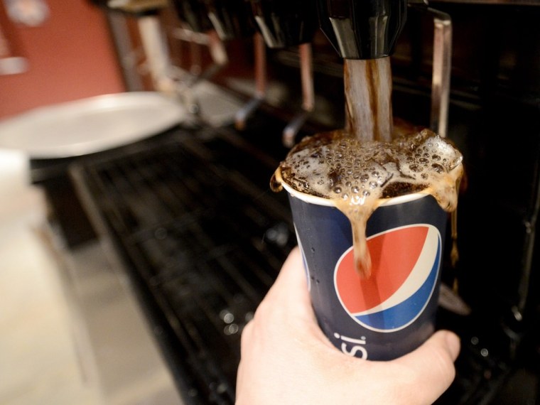 A large soda is filled at a restaurant in New York. A judge invalidated New York City's plan to ban large sugary drinks from restaurants, movie theaters and other establishments one day before the new law was to take effect.